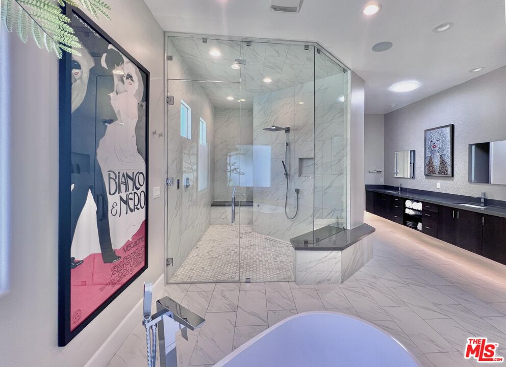 380 Loch Lomond Road Rancho Mirage, CA 92270 - Photo 16 of 39 a large bathroom with a glass door shower and sink