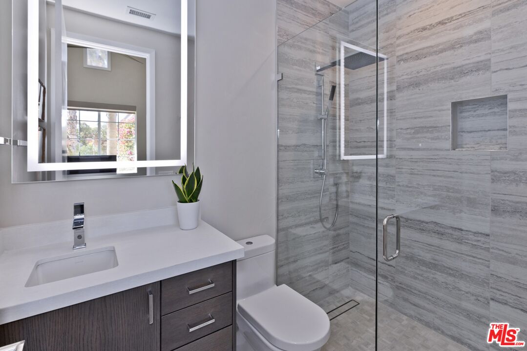 380 Loch Lomond Road Rancho Mirage, CA 92270 - Photo 21 of 39 a bathroom with a sink toilet and shower