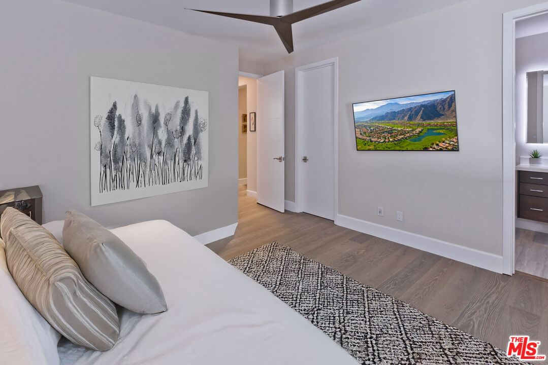 380 Loch Lomond Road Rancho Mirage, CA 92270 - Photo 22 of 39 a bedroom with a bed and a painting on the wall