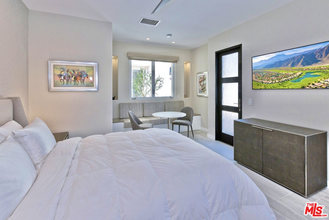 380 Loch Lomond Road Rancho Mirage, CA 92270 - Photo 25 of 39 a bedroom with a large bed and a window