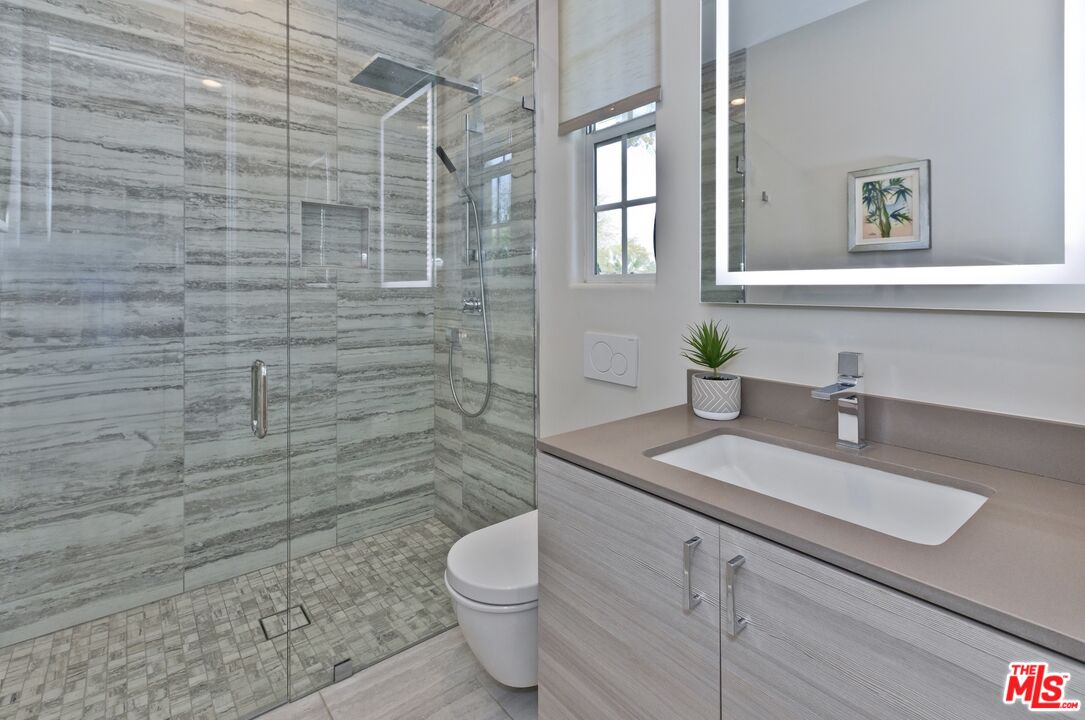 380 Loch Lomond Road Rancho Mirage, CA 92270 - Photo 26 of 39 a bathroom with a granite countertop toilet sink and mirror