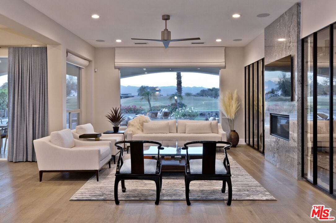 380 Loch Lomond Road Rancho Mirage, CA 92270 - Photo 7 of 39 a dining room with furniture a rug and a chandelier