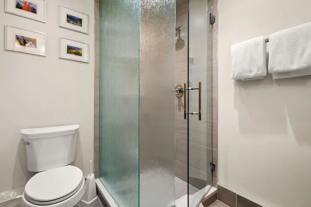 a bathroom with a granite countertop tub sink and mirror