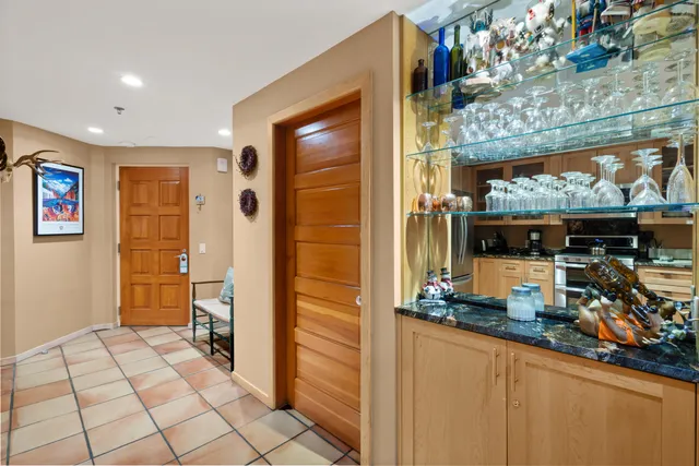 a kitchen with stainless steel appliances granite countertop a refrigerator and a stove top oven
