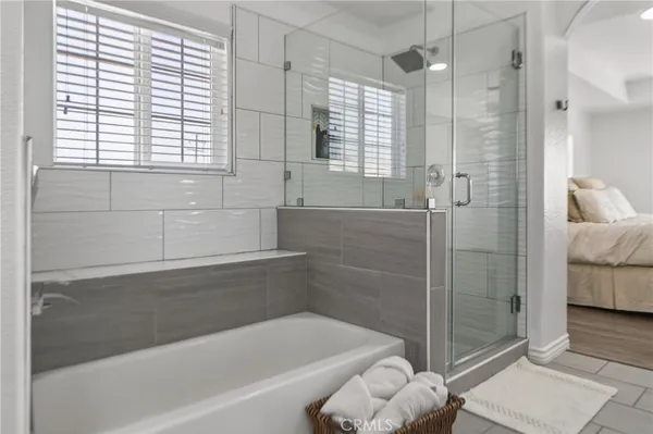 a bathroom with a double vanity sink mirror and shower