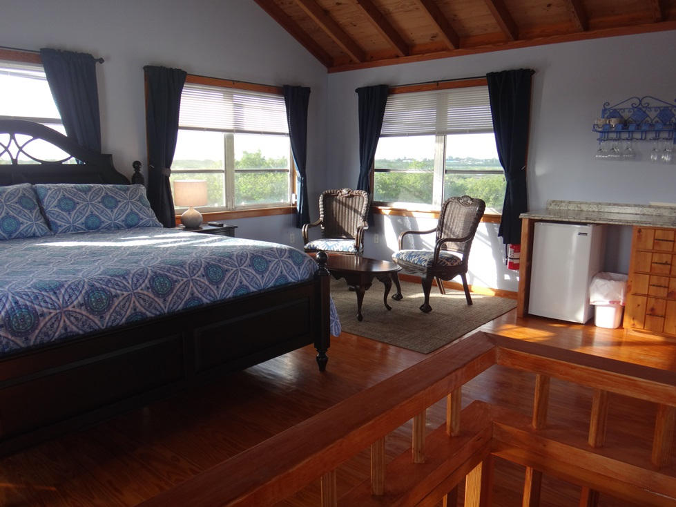 53 Barry Avenue Summerland Key, FL 33042 - Photo 17 of 22 a living room with a bed furniture and a large window