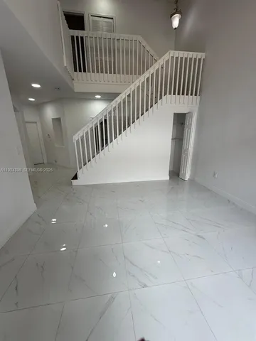 a view of staircase with white walls and stairs