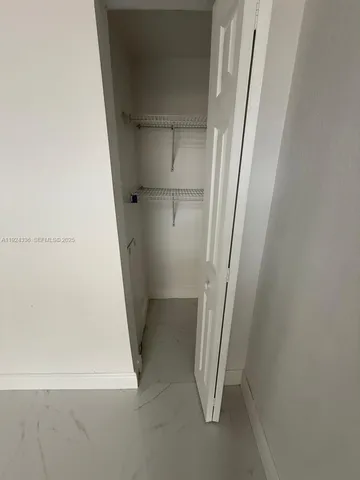 a view of an empty room with sliding glass door