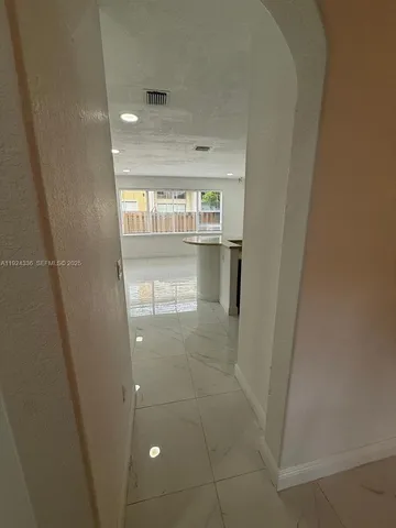 a kitchen with stainless steel appliances granite countertop a sink and a stove