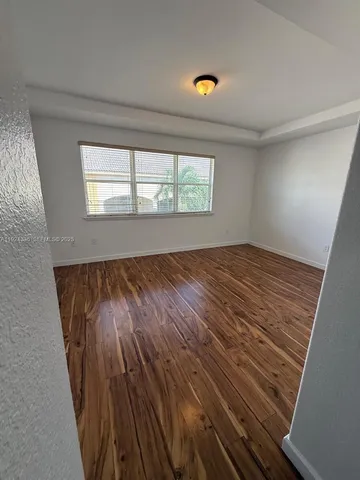 a view of storage and utility room with wooden floor