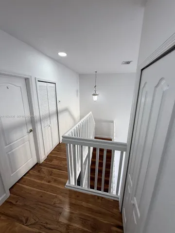 a view of a staircase and wooden floor