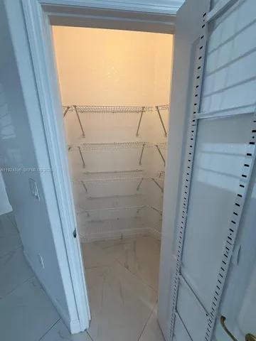 a white toilet sitting next to a shower