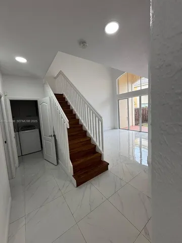 an entryway in a hall with a window