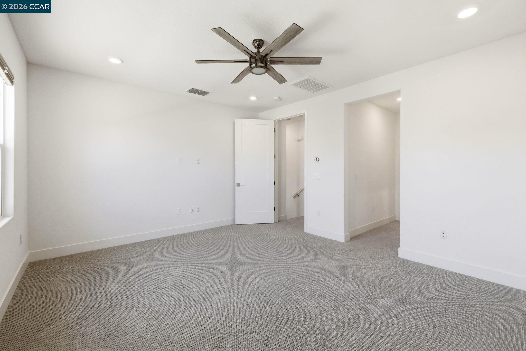 205 Plum Tree Street Livermore, CA 94551 - Photo 28 of 47 an empty room with a ceiling fan and a window