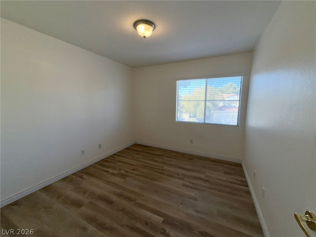 9729 Trail Rider Drive Las Vegas, NV 89117 - Photo 20 of 26 A well-lit bedroom features durable laminate flooring and a large window providing pleasant outdoor views.