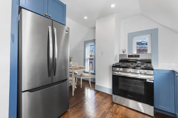 a kitchen with stainless steel appliances a refrigerator stove and microwave