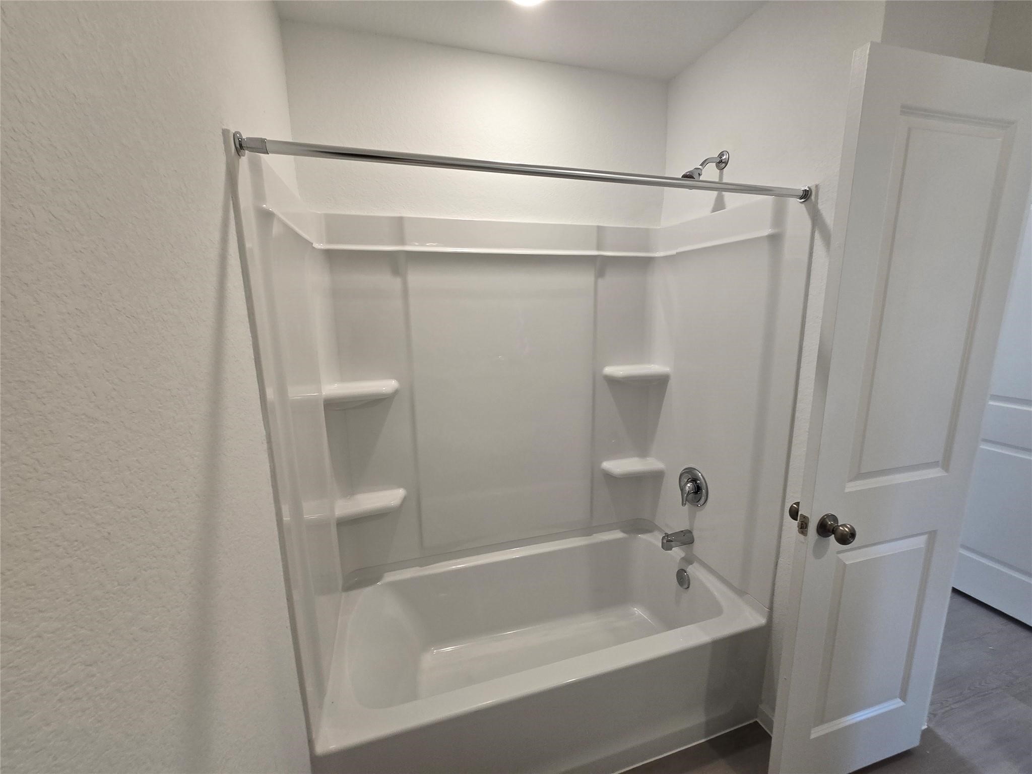2935 Summer Breeze Way Angleton, TX 77515 - Photo 9 of 25 a bathroom with a shower and a bath tub