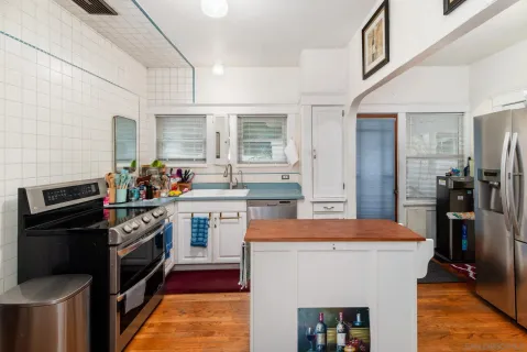 a kitchen with a sink stove and refrigerator