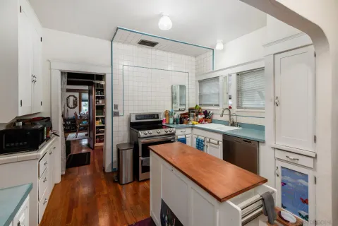a kitchen with stainless steel appliances granite countertop a refrigerator stove microwave and sink