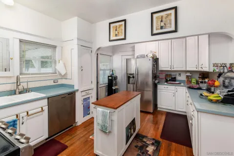 a kitchen with stainless steel appliances a refrigerator stove and sink