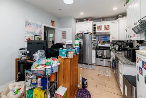a kitchen with stainless steel appliances granite countertop a refrigerator and a stove