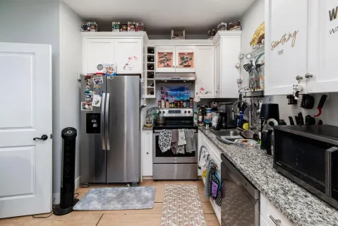 a kitchen with stainless steel appliances granite countertop a stove and cabinets