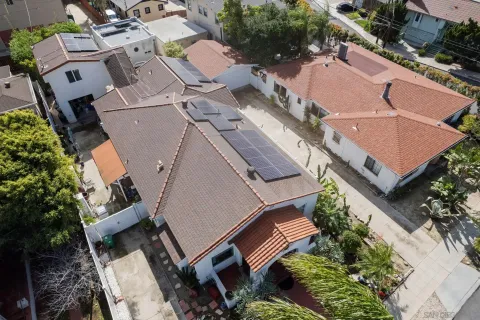 an aerial view of a house with garden space and street view