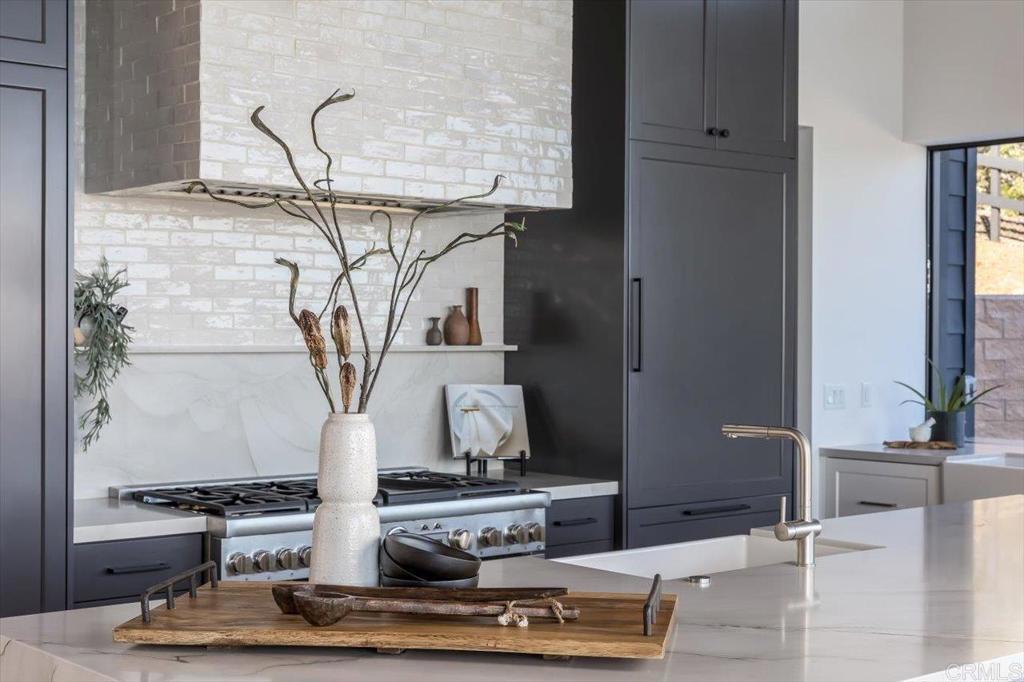 2920 Lone Jack Road Encinitas, CA 92024 - Photo 6 of 23 a living room with a fireplace and potted plants