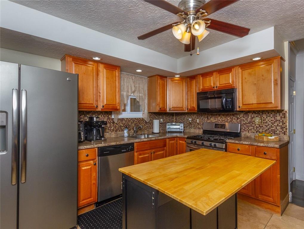 2114 Hampton Street Pittsburgh, PA 15218 - Photo 11 of 28 a kitchen with stainless steel appliances granite countertop a sink a stove and a refrigerator