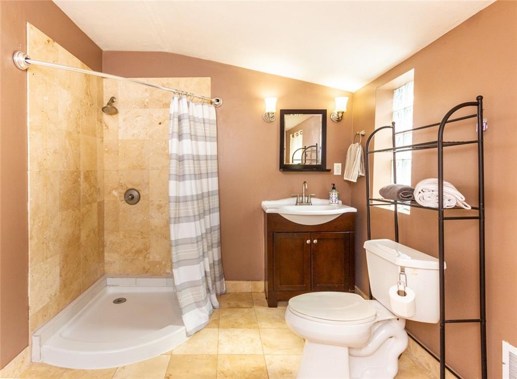 2114 Hampton Street Pittsburgh, PA 15218 - Photo 16 of 28 a bathroom with a sink toilet and shower