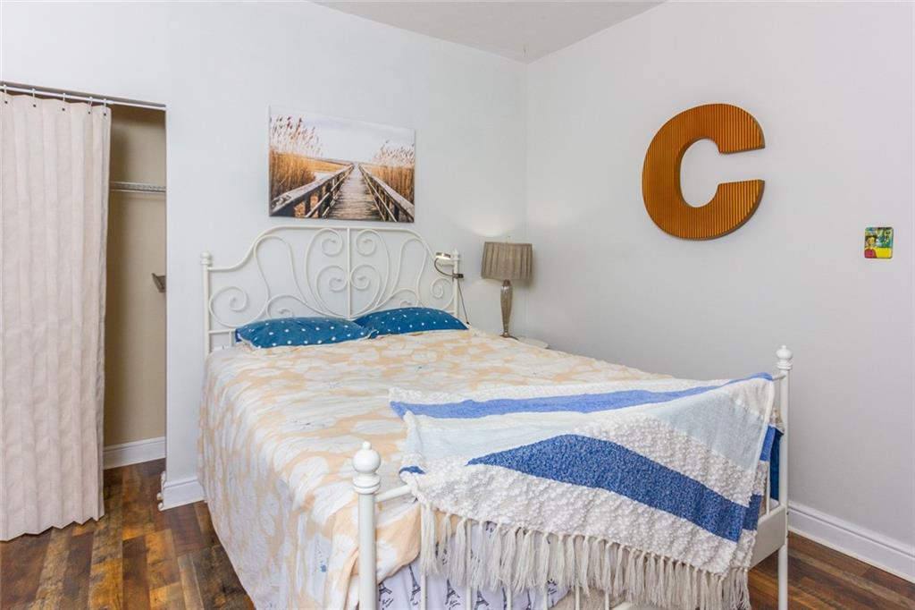 2114 Hampton Street Pittsburgh, PA 15218 - Photo 21 of 28 a bedroom with a bed and a painting on the wall