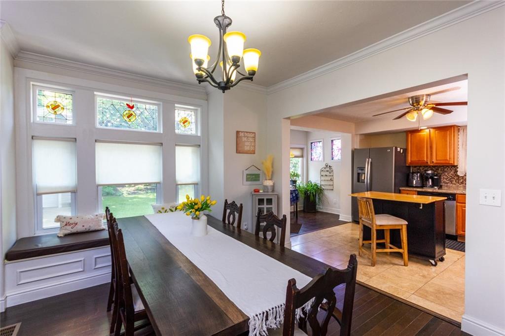 2114 Hampton Street Pittsburgh, PA 15218 - Photo 8 of 28 a view of a dining room with furniture a chandelier and wooden floor