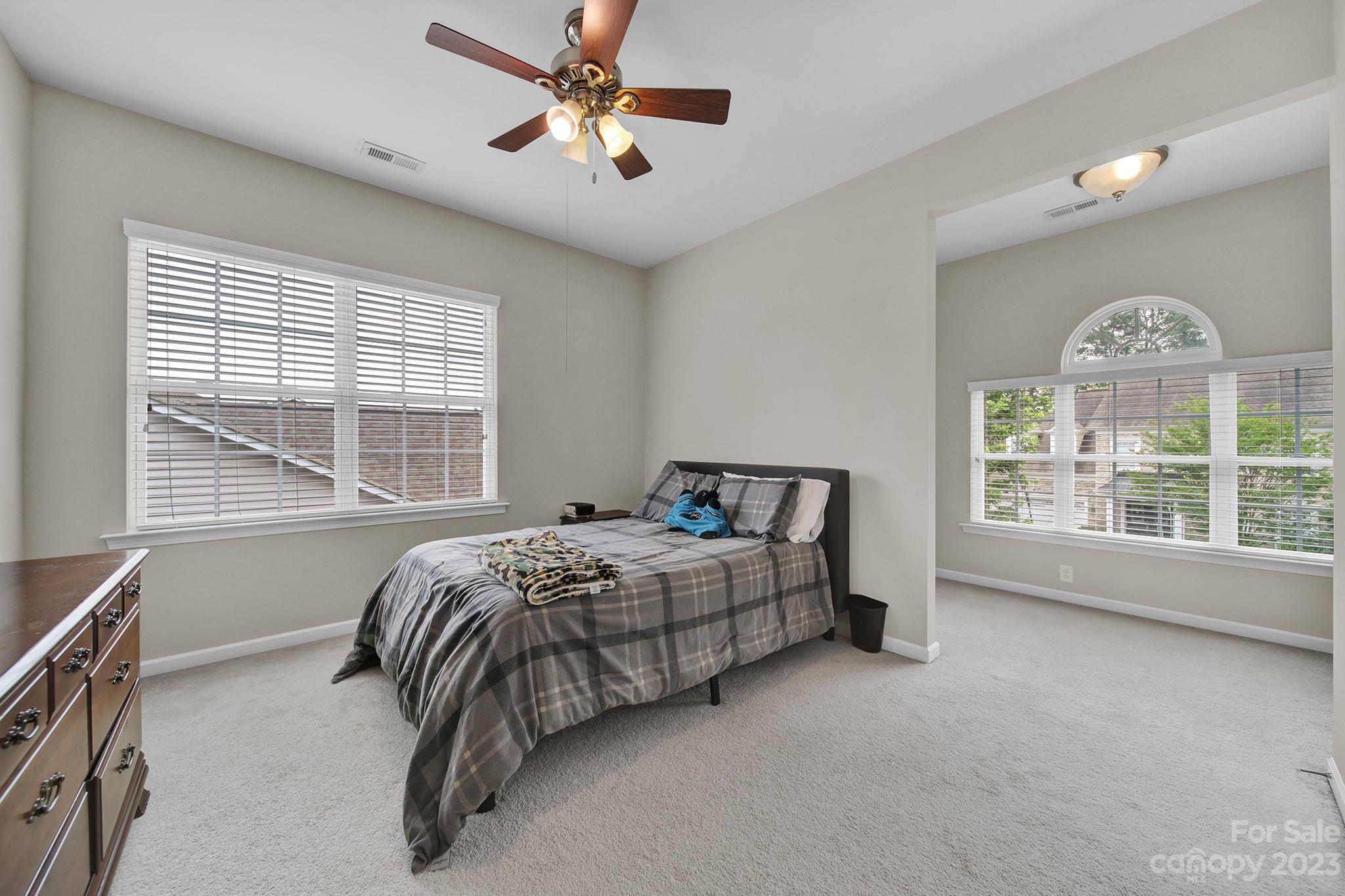 1362 Secret Path Drive Fort Mill, SC 29708 - Photo 28 of 47 a spacious bedroom with a bed next to a window