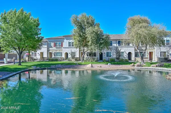 a house view with swimming pool in front of it