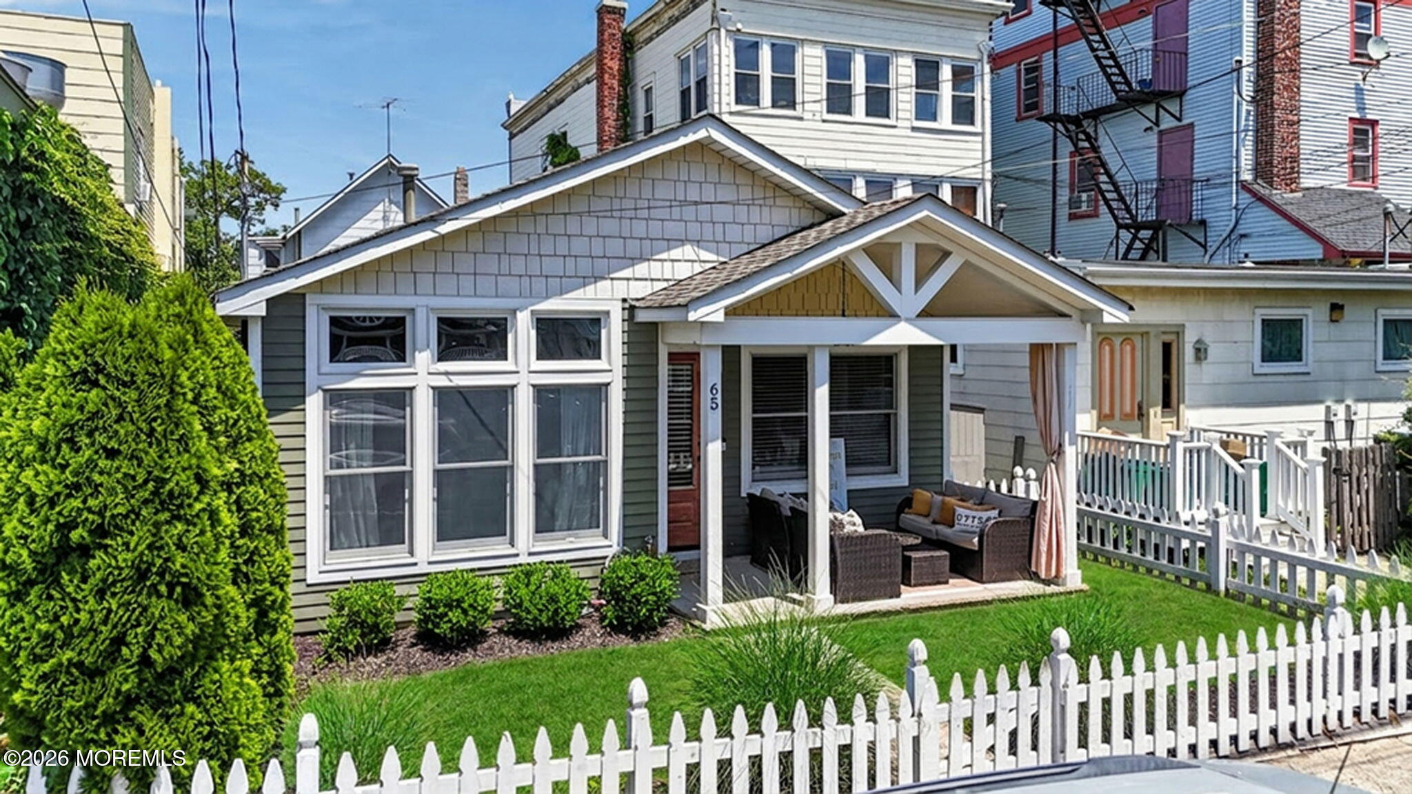 65 Heck Avenue Ocean Grove, NJ 07756 - Photo 5 of 37 a view of a house with a small yard and wooden fence