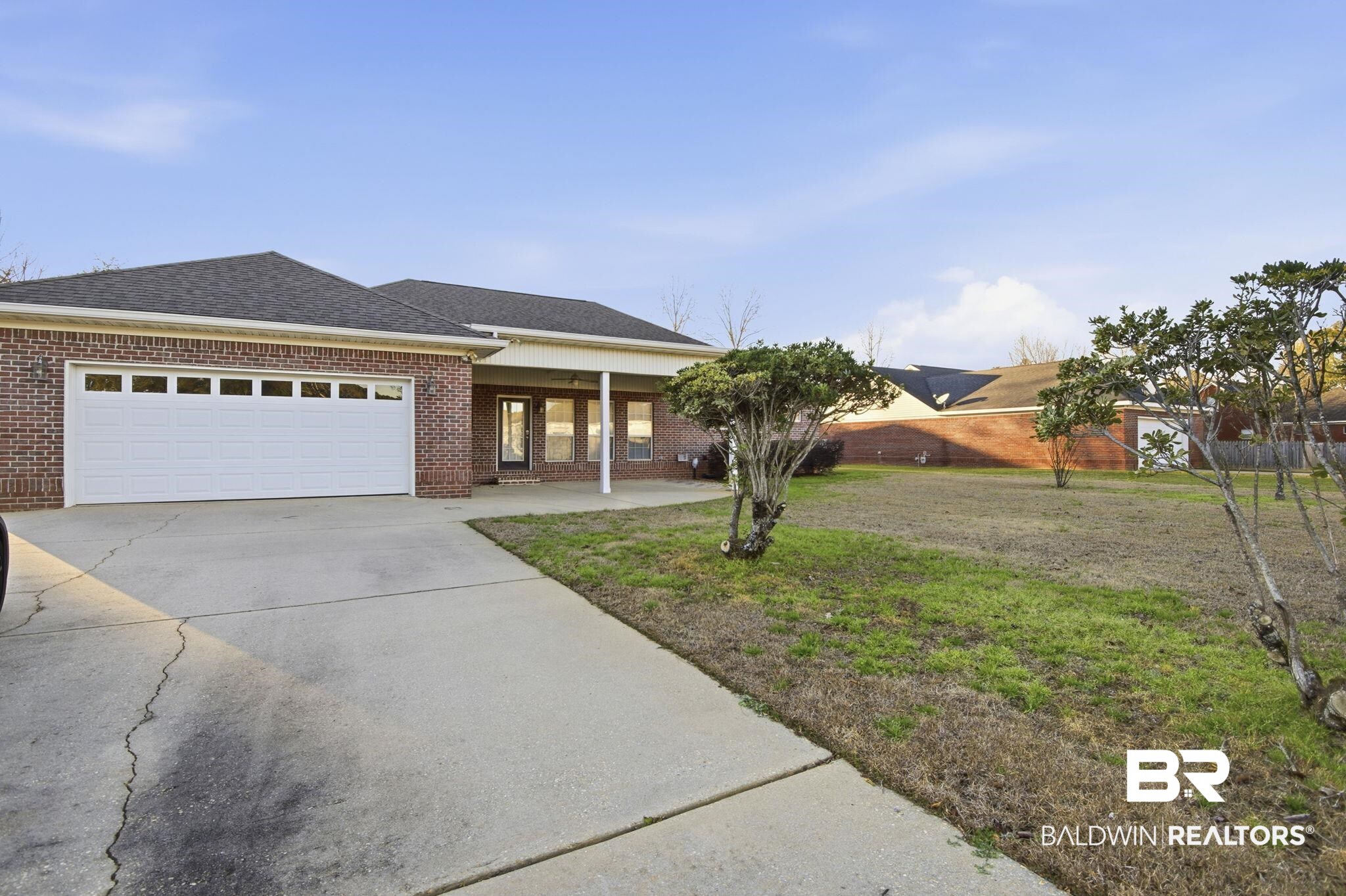 29634 St George Street Daphne, AL 36526 - Photo 6 of 47 Ranch-style home with concrete driveway, brick siding, a shingled roof, and an attached garage