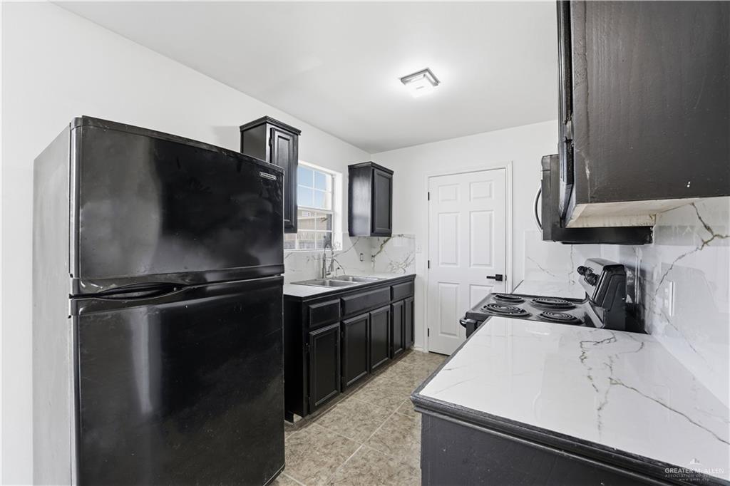 710 Sherryl Avenue Pharr, TX 78577 - Photo 5 of 13 a kitchen with a sink appliances and cabinets