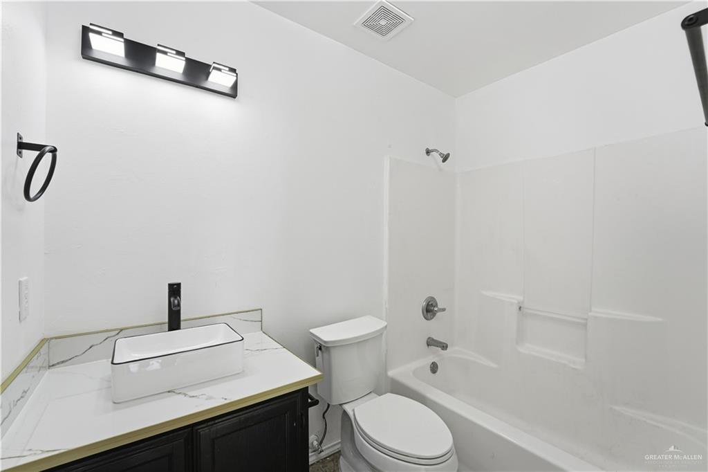 710 Sherryl Avenue Pharr, TX 78577 - Photo 8 of 13 a bathroom with a sink a toilet and shower