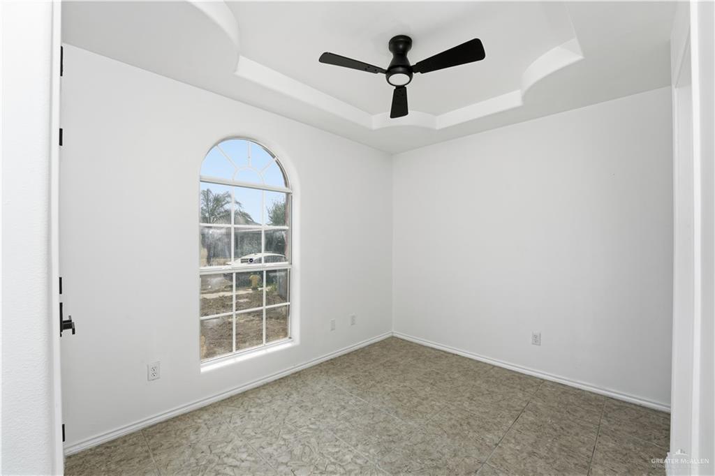710 Sherryl Avenue Pharr, TX 78577 - Photo 9 of 13 an empty room with ceiling fan and window