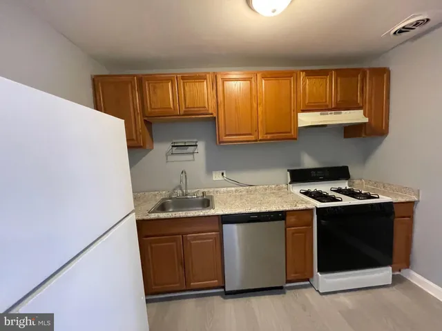 a kitchen with a sink stove and cabinets