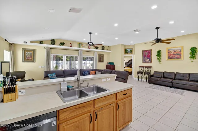 a kitchen with stainless steel appliances granite countertop a sink and a refrigerator