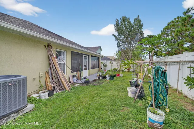 a view of a house with backyard and a patio