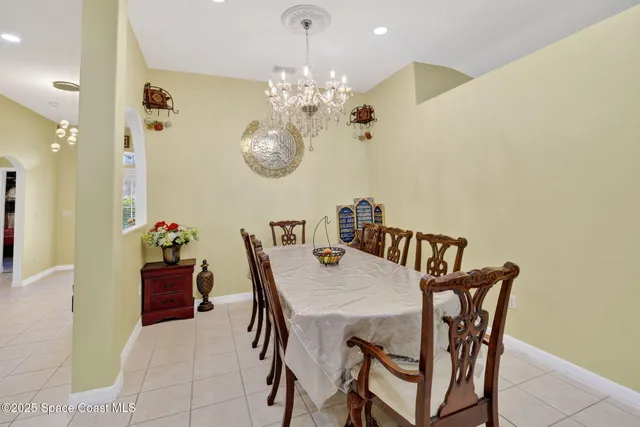 a view of a dining room with furniture and chandelier