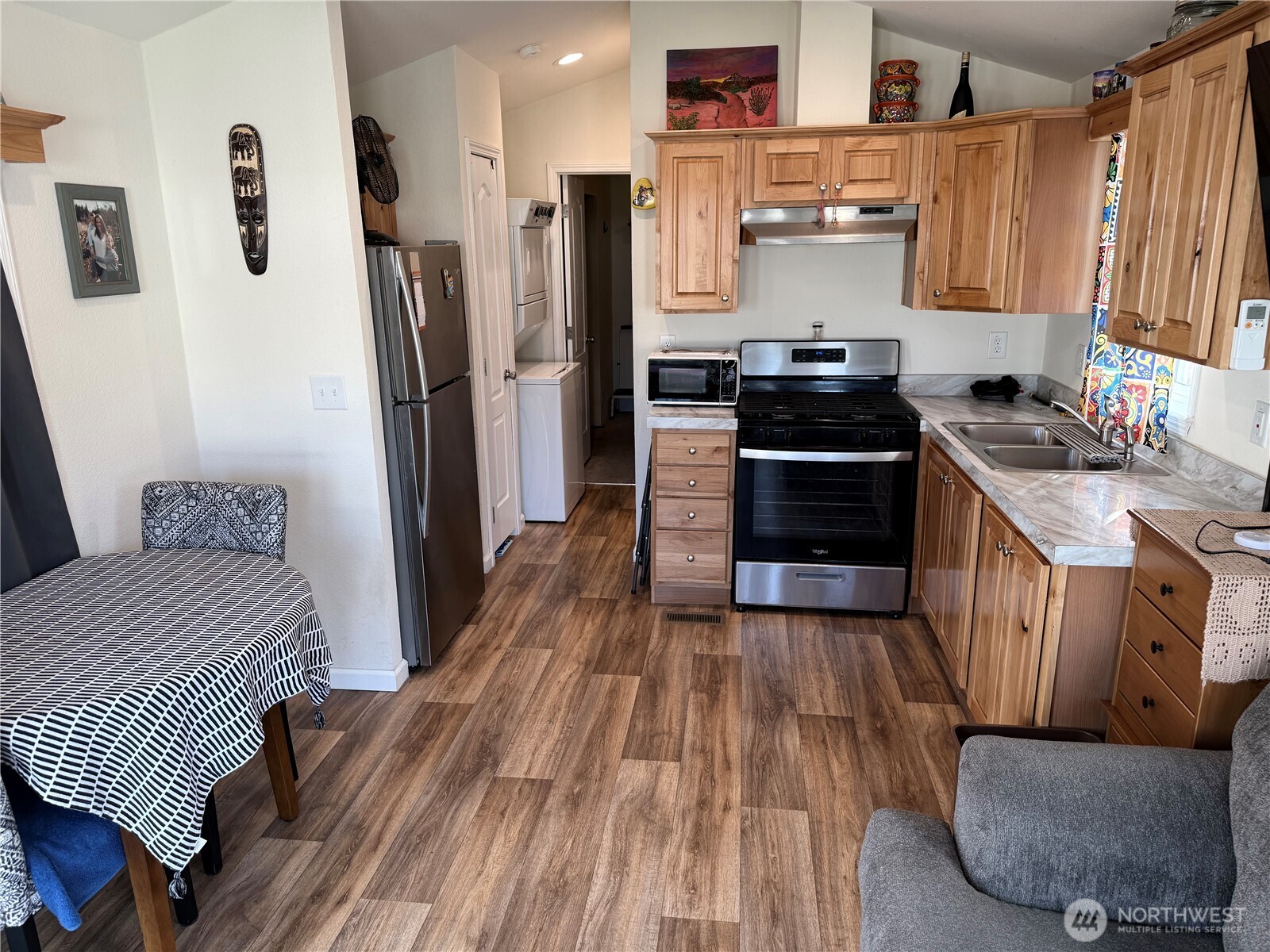 31465 Moore Road Northeast, Unit 801 Coulee City, WA 99115 - Photo 5 of 38 a kitchen with stainless steel appliances a stove a refrigerator and wooden cabinets