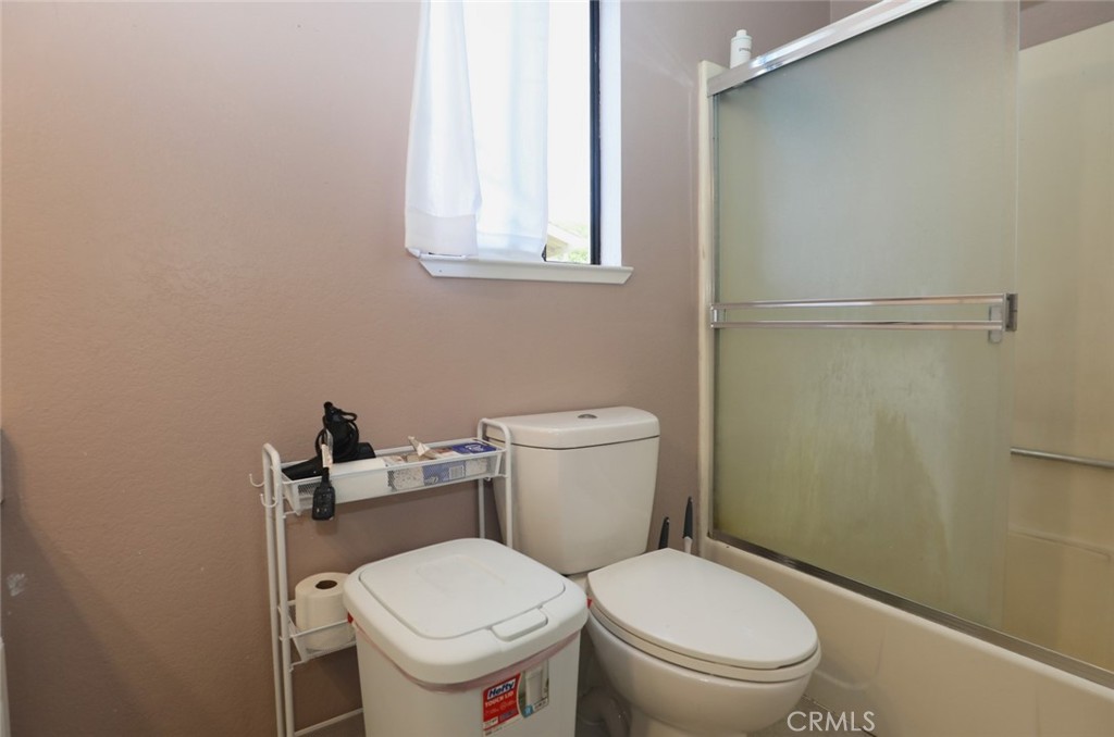 19425 Old Creek Road Hidden Valley Lake, CA 95467 - Photo 25 of 41 a white toilet sitting next to a bathroom sink and a window