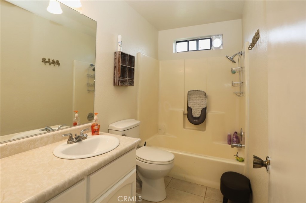 19425 Old Creek Road Hidden Valley Lake, CA 95467 - Photo 28 of 41 a bathroom with a granite countertop sink toilet and shower