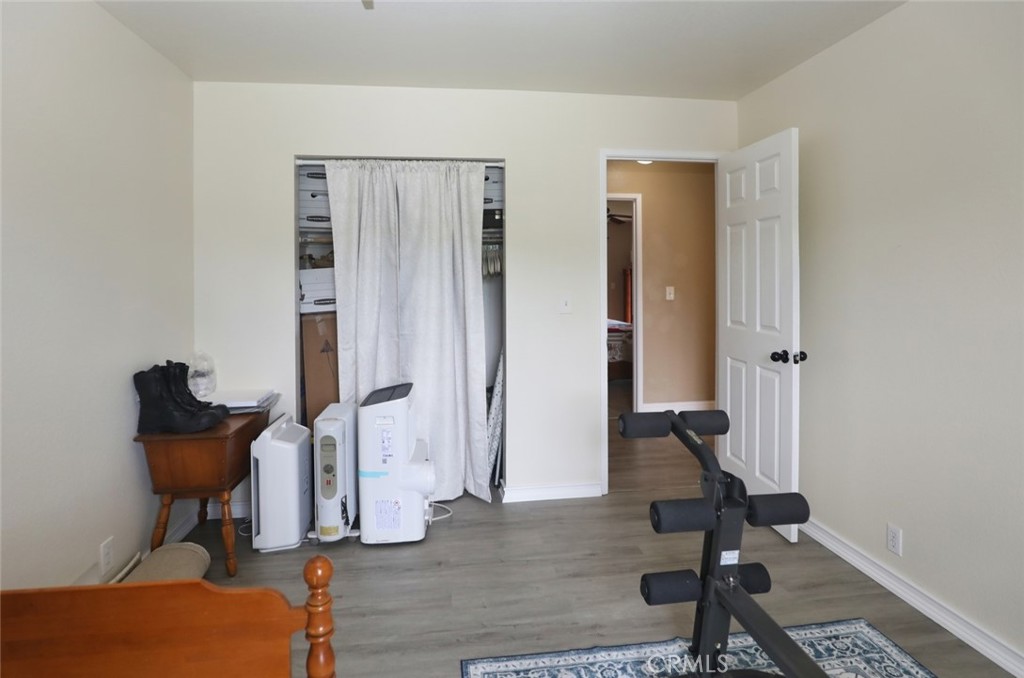 19425 Old Creek Road Hidden Valley Lake, CA 95467 - Photo 29 of 41 a view of a hallway with wooden floor and furniture