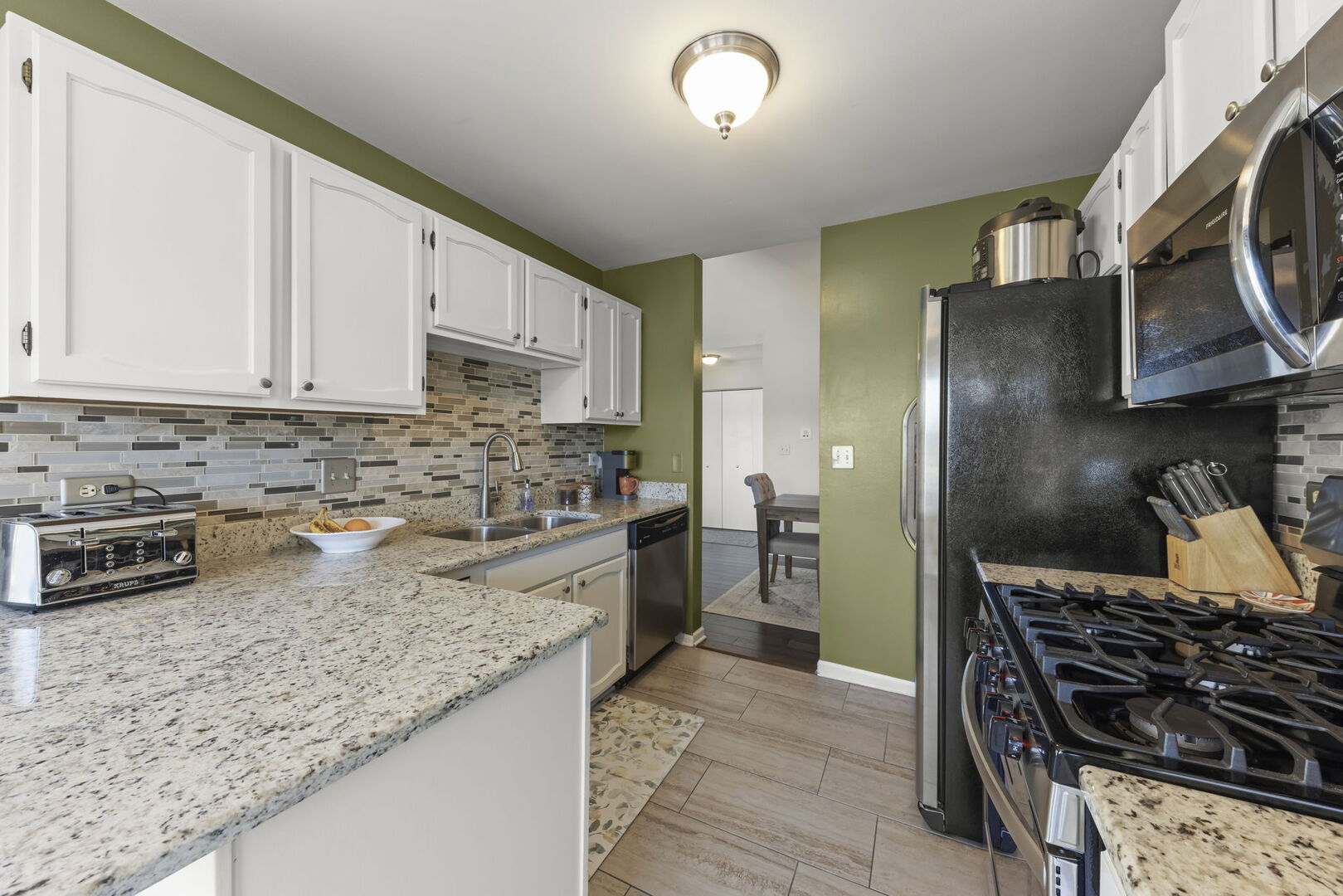 -n204 Windermere Road, Unit 2708 Winfield, IL 60190 - Photo 12 of 36 a kitchen with a stove a sink and a refrigerator