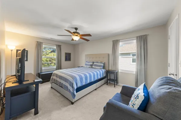 a spacious bedroom with a bed and a couch