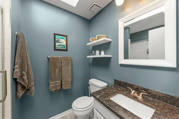 a white toilet sitting next to a bathroom sink